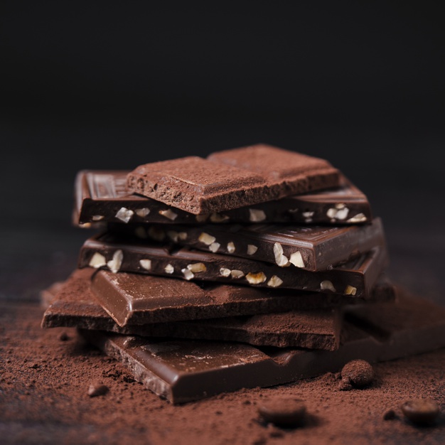 chocolate-bars-tower-with-cocoa-powder_23-2148357770